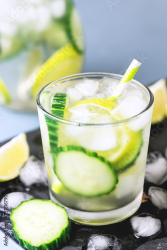 Cold and Refreshing Infused Detox Water with Lime and Cucumber in a Glass With Ice Cube Healthy Detox Drink Vertical