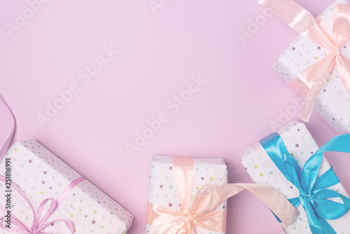 Fototapeta Naklejka Na Ścianę i Meble -  Variety of Gift Boxes on Pastel Pink Background Shopping Sales or Holidays Concept Holiday Background Top View Horizontal Copy Space Frame