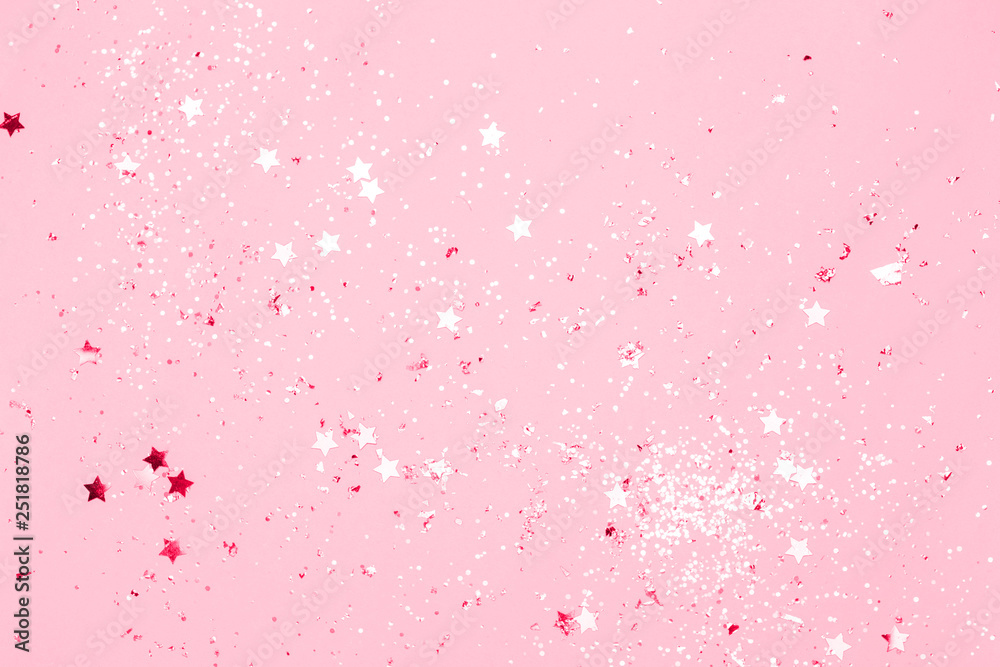 Pink confetti and stars and sparkles on pink background. Top view, flat lay. Copyspace for text. Bright and festive holiday background. For Christmas, New year, Mother's day. Pink confetti and stars and sparkles on pink background. Top view, flat lay. Copyspace for text. Bright and festive holiday background. For Christmas, New year, Mother's day.