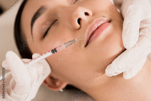 close up of beautiful asian woman getting beauty injection at clinic