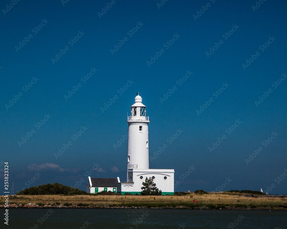 White Lighthouse against a dark sky