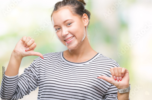 Young beautiful caucasian woman over isolated background looking confident with smile on face, pointing oneself with fingers proud and happy.