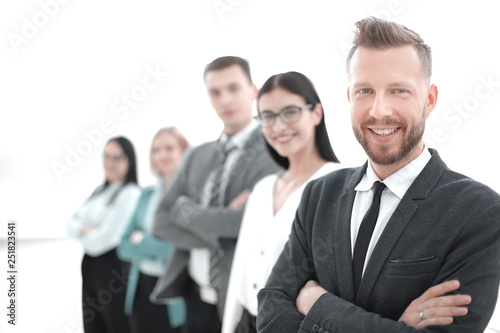 confident businessman standing in front of his business team