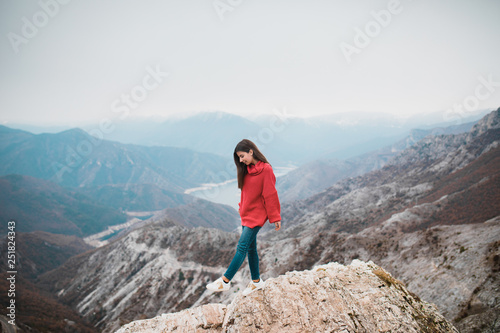 Beautiful Young Girl in a cosy red sweater on Mountain top © Suteren Studio