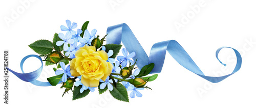 Yellow roses and blue small flowers with silk ribbon in a floral arrangement