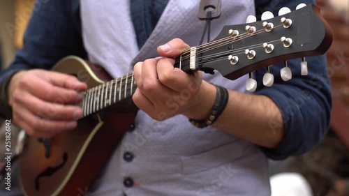 Close up of male play on the mandolin