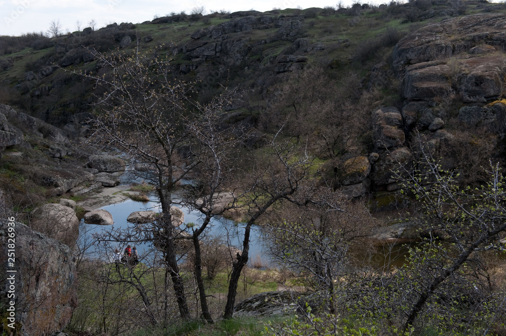 Ukrainian landscape with river, boulders, and mountains Ukrainian landscape with river, boulders, and mountains