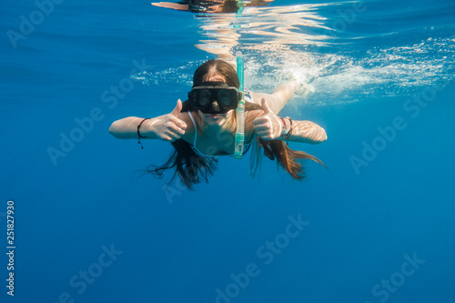 Girl in swimming mask dive in Red sea