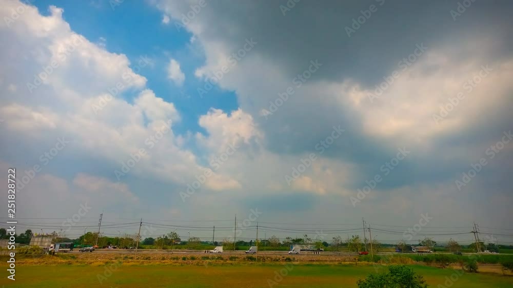 Clouds and cars moving on road in green fields. with blue sky Time lapse Clouds and cars moving on road in green fields. with blue sky Time lapse