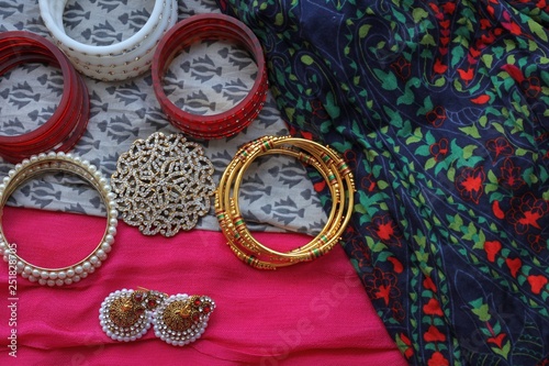 Indian decorations for dancing: bracelets, earrings for dancing bharatanatyam or kathak. Fabric background.