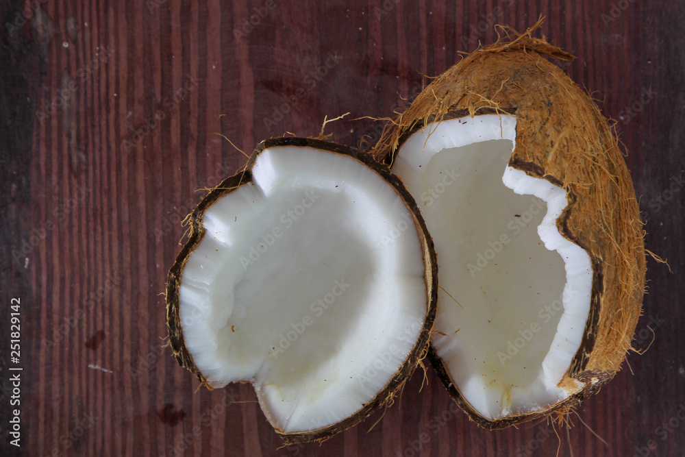 Half of coconut on wooden background Half of coconut on wooden background