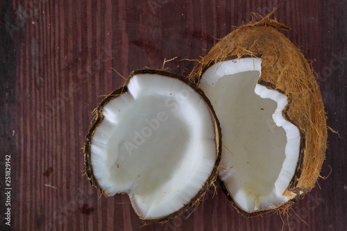 Half of coconut on wooden background