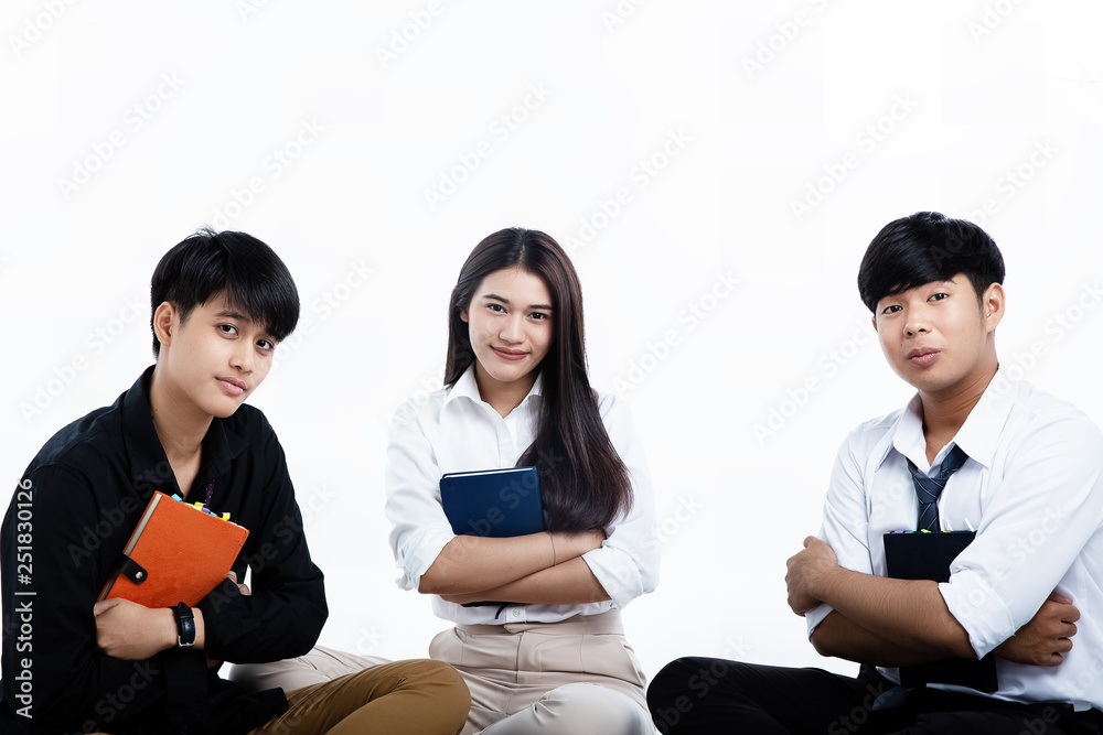 Three young teenagers holding book in their arms,prepare for revise for an exam Three young teenagers holding book in their arms,prepare for revise for an exam