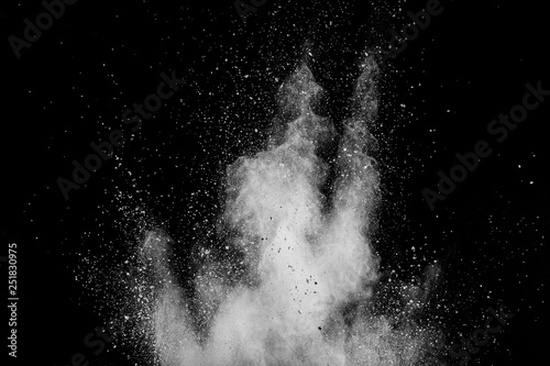 White powder explosion isolated on black background. White dust particles splash.Color Holi Festival.