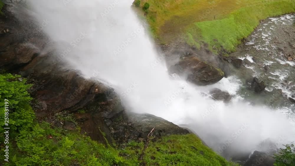 Falls in mountains of Norway in rainy weather. Steindalsfossen waterfall in a rainy day. It is possible to walk under this waterfall. Steinsdalsfossen - one of the gorgeous waterfalls in Norway. Falls in mountains of Norway in rainy weather. Steindalsfossen waterfall in a rainy day. It is possible to walk under this waterfall. Steinsdalsfossen - one of the gorgeous waterfalls in Norway.