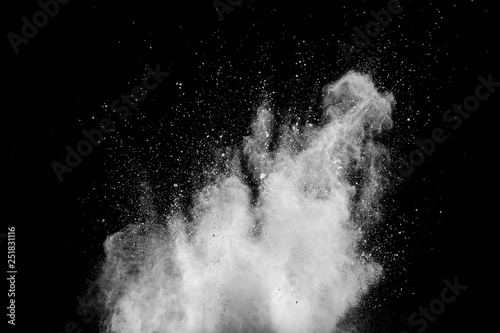 White powder explosion isolated on black background. White dust particles splash.Color Holi Festival.