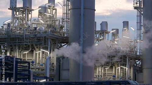 Oil refinery plant at sunrise with sky background