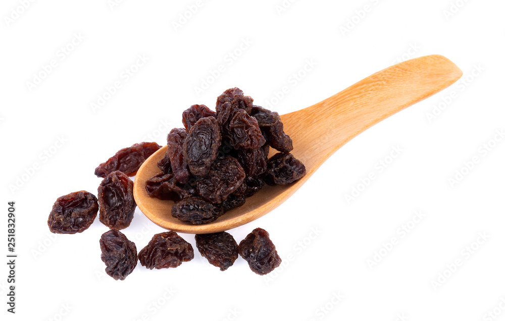 Dried raisins in spoon on white background