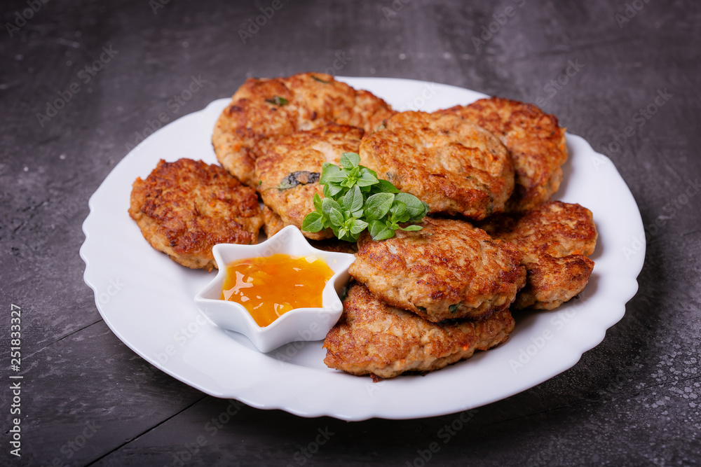 Homemade cutlets from minced fish with sauce