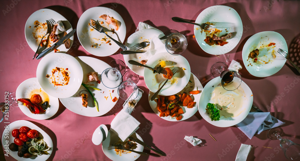Fototapeta premium Dirty dishes on a table in a restaurant. After eating