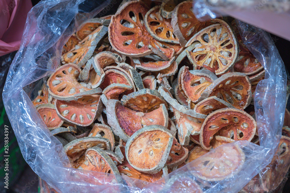 Aegle marmelos. Dried Bael fruit in plastic background.