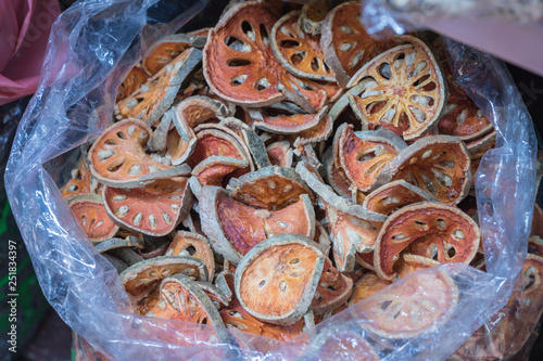 Aegle marmelos. Dried Bael fruit in plastic background.
