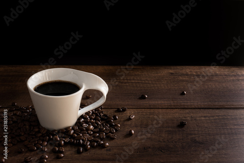 Coffee Cup and Coffee bean on wood table