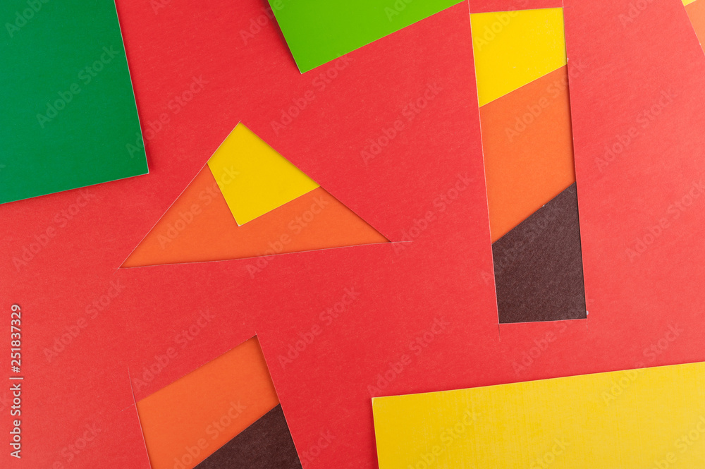 Multi-colored real vivid paper sheets texture background. Red, brown, yellow, orange, green.