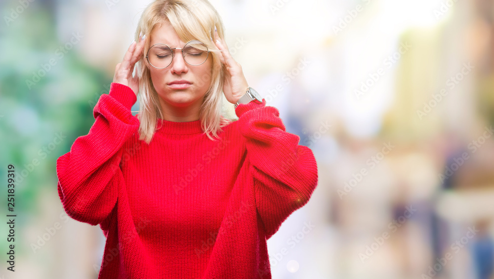 Young beautiful blonde woman wearing sweater and glasses over isolated background with hand on head for pain in head because stress. Suffering migraine.
