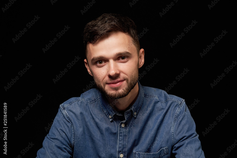 Handsome man in denim shirt looking at camera smiling Handsome man in denim shirt looking at camera smiling