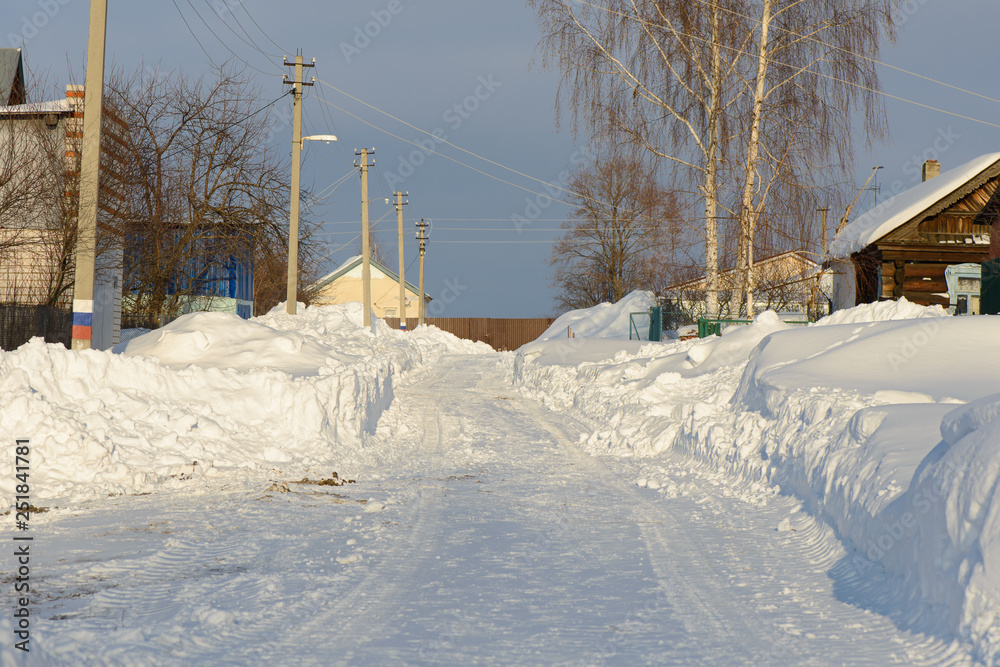 February 10, 2019: Snowy street of the village Sugaikasy on a sunny winter day. Kanashsky area. Chuvashia Russia. February 10, 2019: Snowy street of the village Sugaikasy on a sunny winter day. Kanashsky area. Chuvashia Russia.