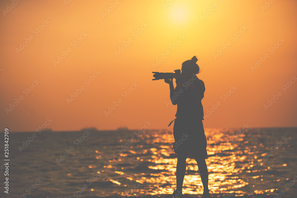 Silhouette of  woman taking pictures