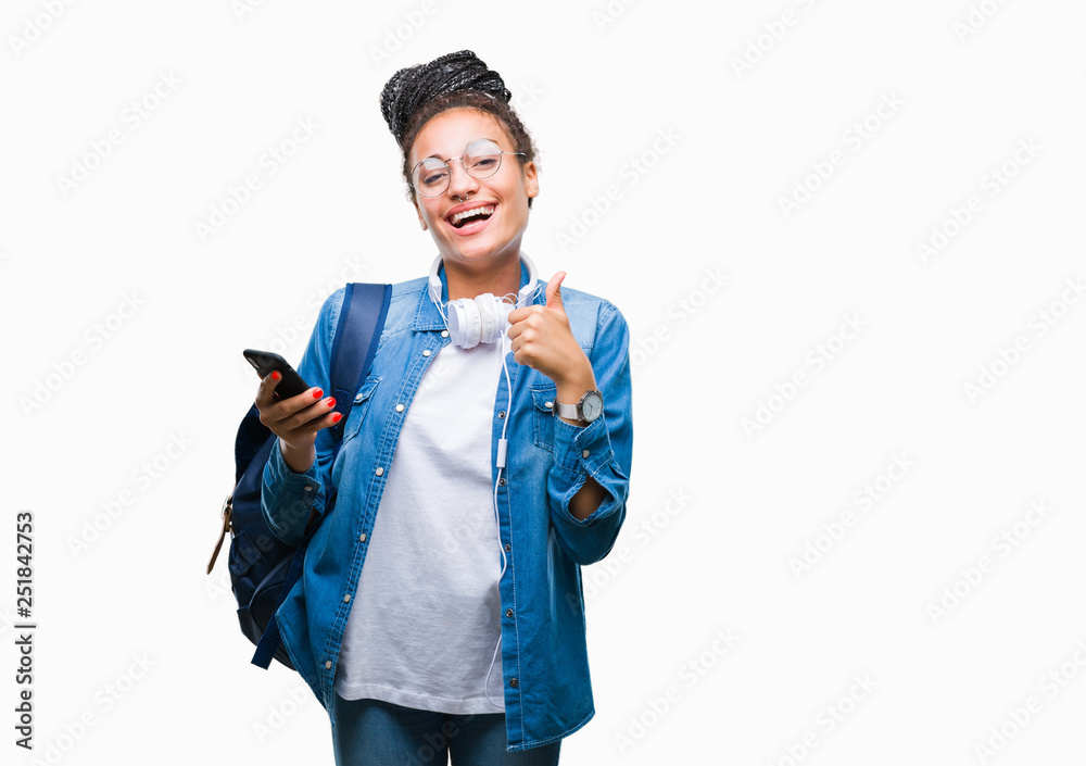 Young braided hair african american student girl using smartphone over isolated background happy with big smile doing ok sign, thumb up with fingers, excellent sign Young braided hair african american student girl using smartphone over isolated background happy with big smile doing ok sign, thumb up with fingers, excellent sign