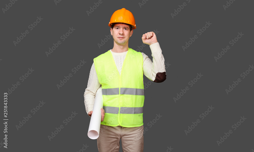 the civil engineer keeps a fist about a shoulder in a helmet, friendship gesture the civil engineer keeps a fist about a shoulder in a helmet, friendship gesture