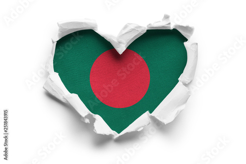 Heart shaped hole torn through paper, showing satin texture of flag of Bangladesh. Isolated on white background
