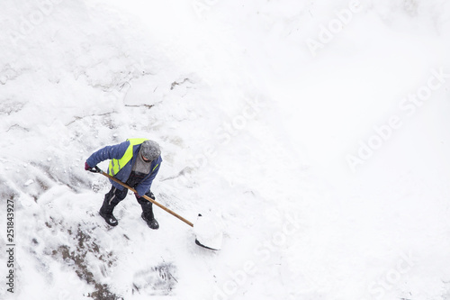 Wall Mural Man shoveling snow after snowfall and blizzard, copy space
