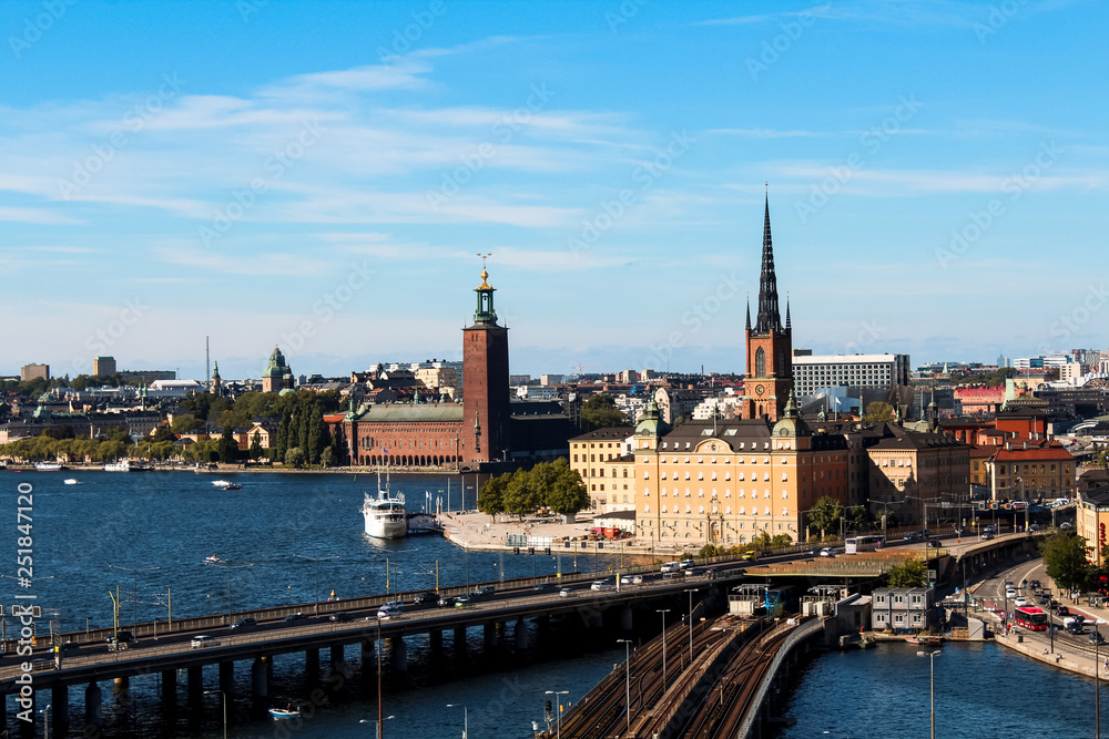 View onto Gamla Stan, Riddarholmskyrkan and Stockholm Stadshus with waterfront as seen from Södermalm during a hot summer day (Stockholm, Sweden, Europe)
