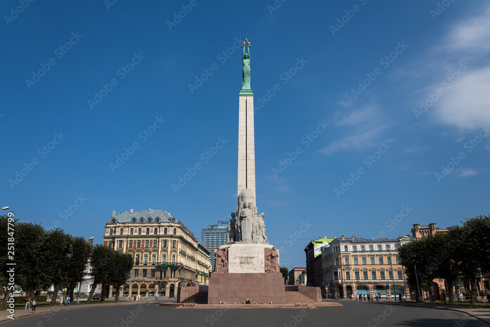 View onto Freedom Monument (Brivibas Piemineklis) in the capital of Latvia, Riga during autumn with clear blue sky (Riga, Latvia, Europe)