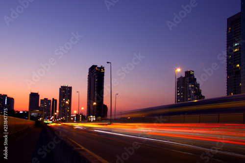 Blurred background image. Traffic lights on city streets at sunset.