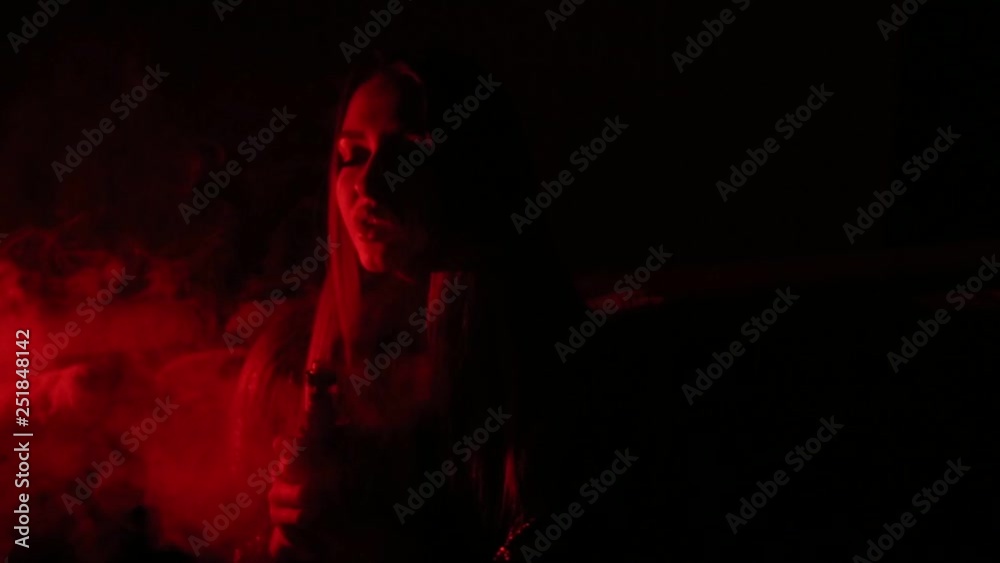 Luxury brunette smokes an electronic cigarette close-up. Vape. Luxury brunette smokes an electronic cigarette close-up. Vape.