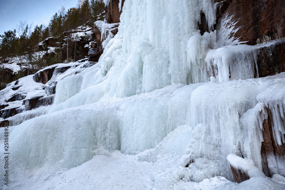 Frozen ice on rocks from a waterfall in the mountains Frozen ice on rocks from a waterfall in the mountains