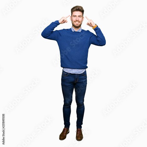 Young handsome bussines man Smiling pointing to head with both hands finger, great idea or thought, good memory