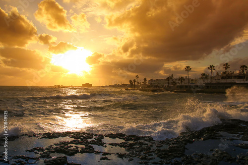 Sunset with view to Paphos Castle with big waves  Cyprus