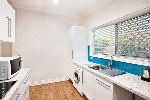 Compact fitted kitchenette with washing machine photo