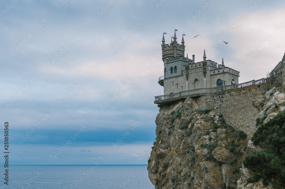 Castle Swallow's Nest on a rock at Black Sea, Crimea, Russia. It is a symbol and tourist attraction of Crimea. Scenic panoramic view of the Crimea southern coast. Architecture and nature of Crimea.