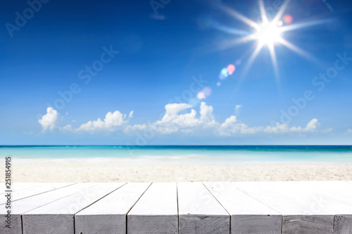 Desk of free space for your decoration and blue sea with beach landscape. Summer sun on sky. 