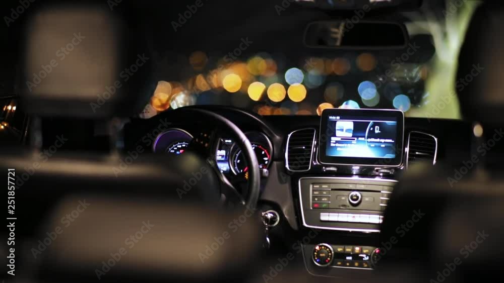 Empty car with navigator. Blurred lights in ahead. Automobile without people. Indoors. Night time, motor, new, nobody, panel, passenger Empty car with navigator. Blurred lights in ahead. Automobile without people. Indoors. Night time, motor, new, nobody, panel, passenger