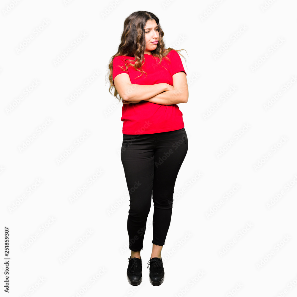 Young beautiful woman wearing casual t-shirt smiling looking to the side with arms crossed convinced and confident Young beautiful woman wearing casual t-shirt smiling looking to the side with arms crossed convinced and confident