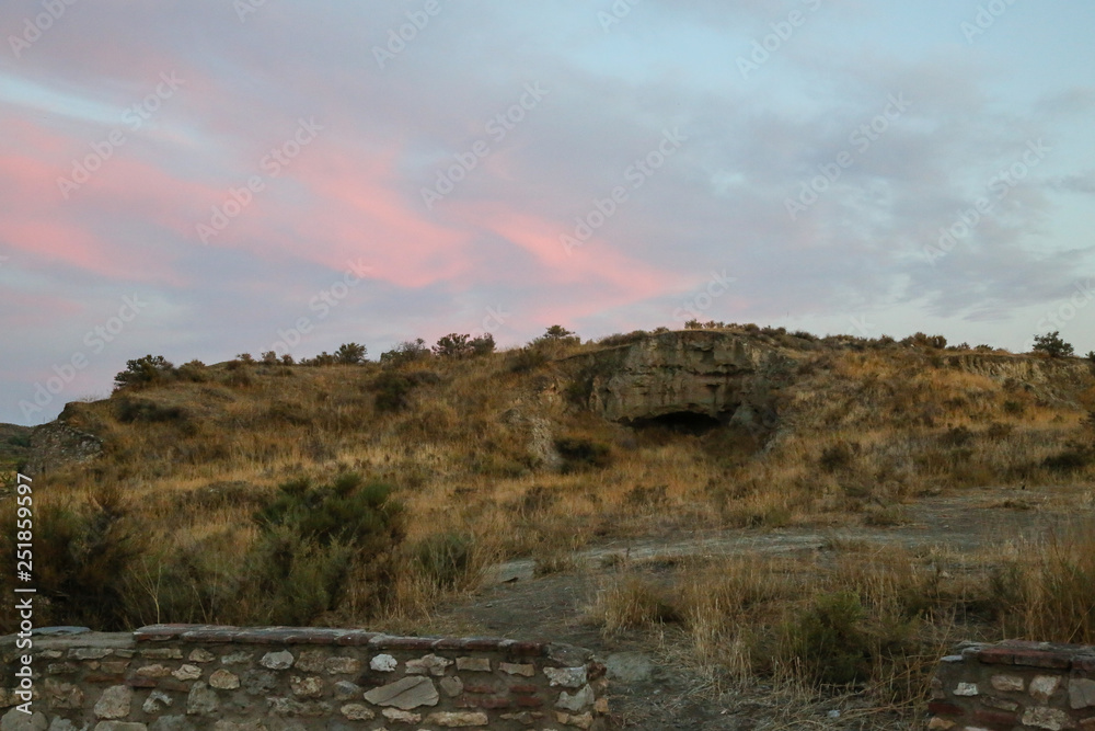 sunset in the mountains over ruins in the ruff steppe
