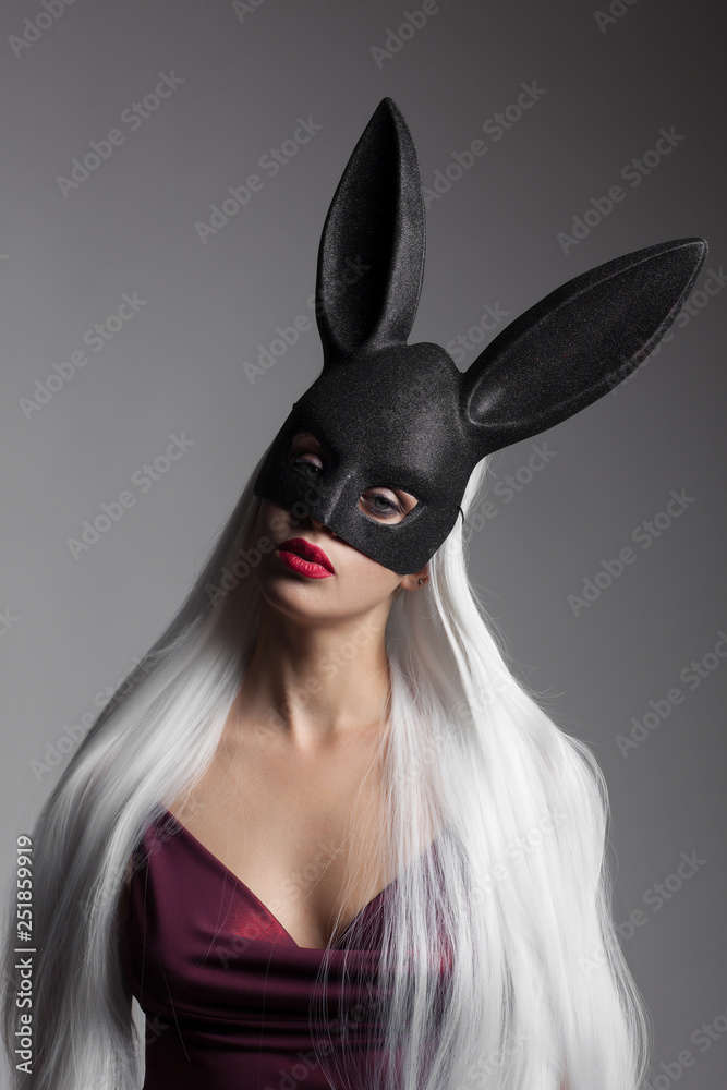 The charming girl with long straight white hair and black rabbit mask on her head The charming girl with long straight white hair and black rabbit mask on her head